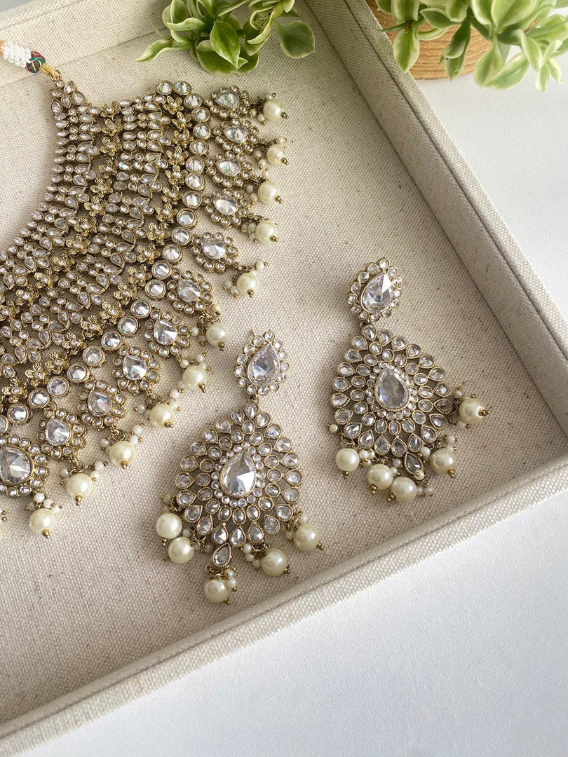Festive Essentials - Beena bib Bridal set is our pride. It is perfect for those brides looking for heavy necklace with matching earrings and tikka. If you want any specific color other than mention above, and for any other inquiries please contact us on whatsapp at +1(313)7271045.