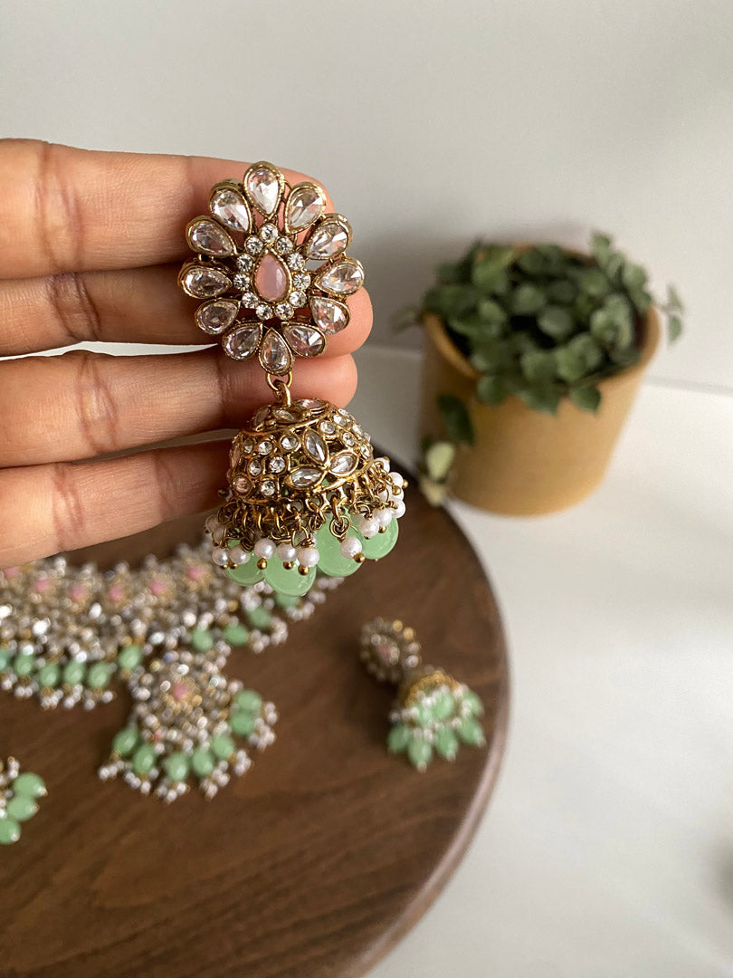 Nusrat bib set is ultimate graceful piece, its&nbsp; flower petal and leaf shape enhaves its beauty. Its gold plating with clear white stone and mint beads combine with pink stone to give you trending look.  If you want any specific color other than mention above, and for any other inquiries please contact us on whatsapp at +1 (313) 727 1045. We are very proud of our highest quality and specialized craftsmanship. Ready to ship from Michigan, United states and we do International Shipping also.